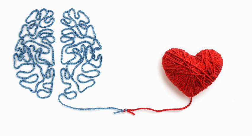 Yarn artwork depicting a brain and a heart connected.
