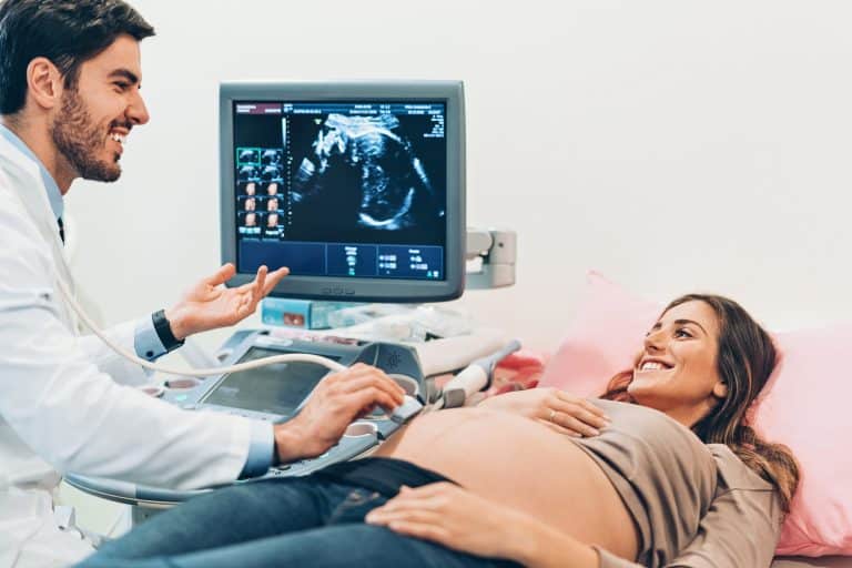 Doctor and a pregnant woman during ultrasound exam in the hospital