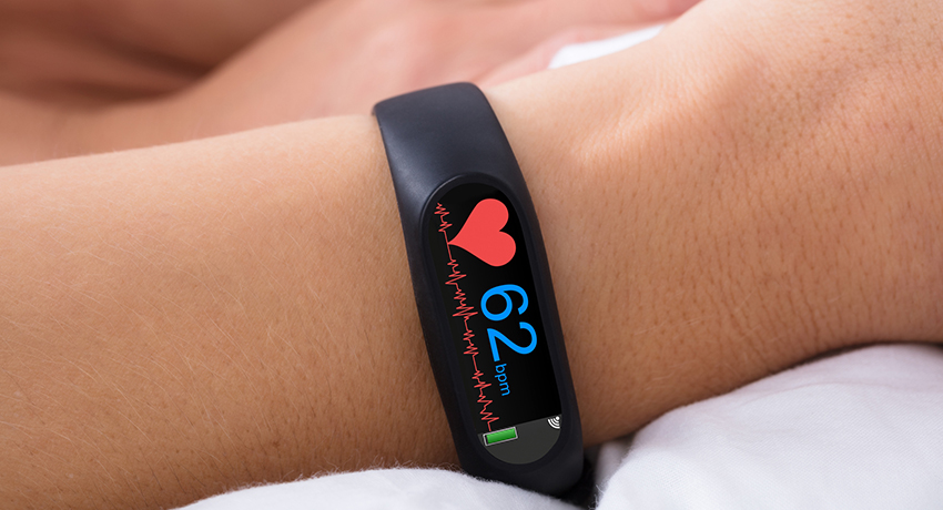 Closeup of a smart watch on a person's wrist with heart rate monitoring visible
