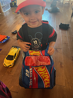 Ignacio wearing his monster truck costume at home