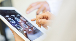 Doctors evaluating and MRI scan on a tablet device