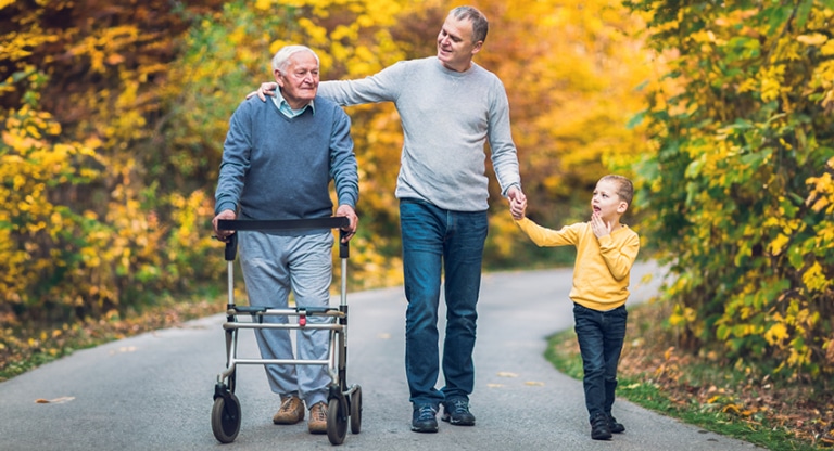Father and son walking with Elderly Grandfather