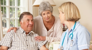 Nurse checking up on senior man