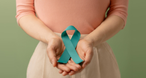 Woman Holding Teal Ribbon on Lower Abdomen, Uterus, Female Reproductive System, Women's Health, PCOS and Gynecology